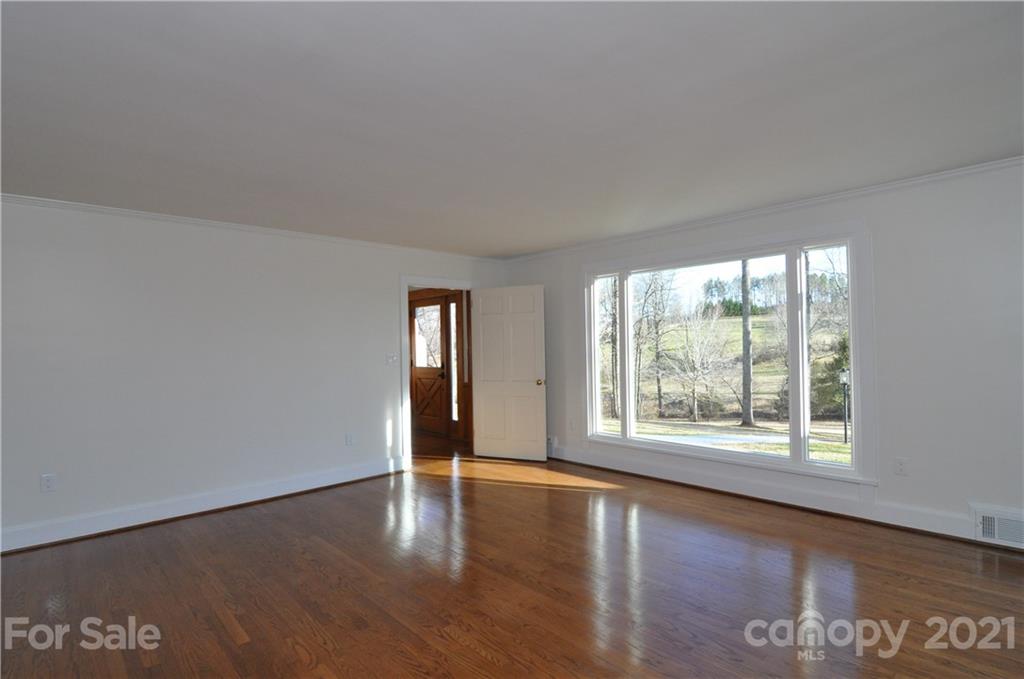 1011 Redland Road Landrum, SC 29356 - Photo 19 of 45 a view of an empty room with wooden floor and a window