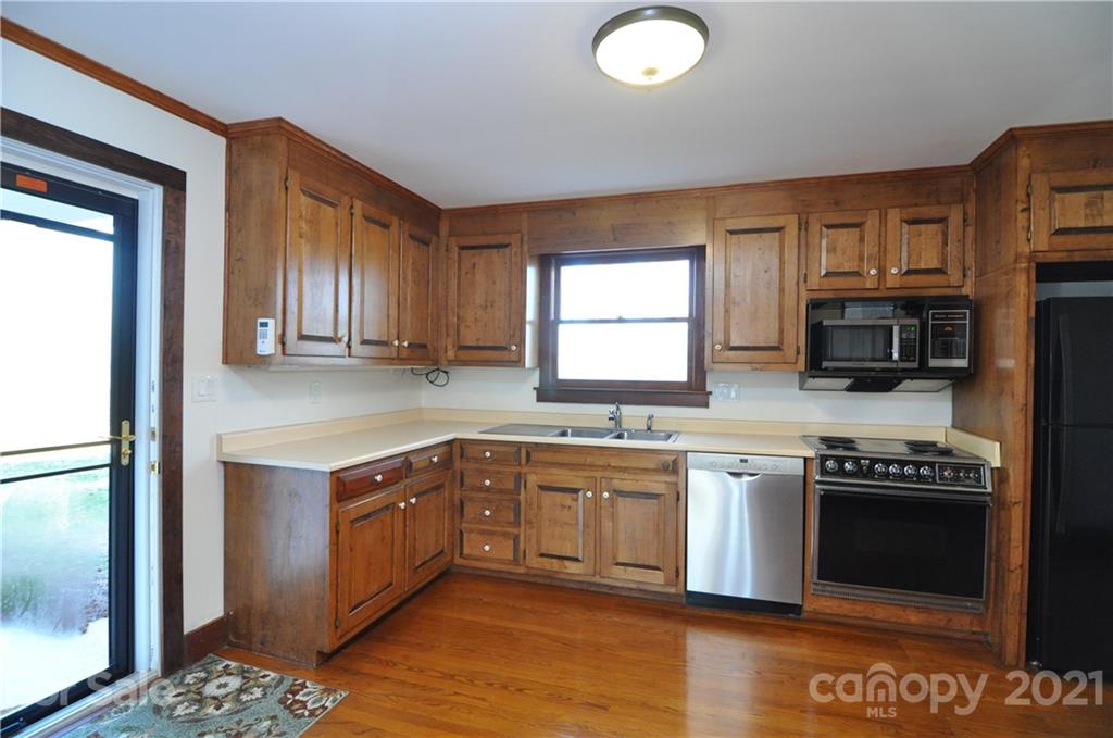1011 Redland Road Landrum, SC 29356 - Photo 29 of 45 a kitchen with stainless steel appliances granite countertop a stove a sink and a microwave