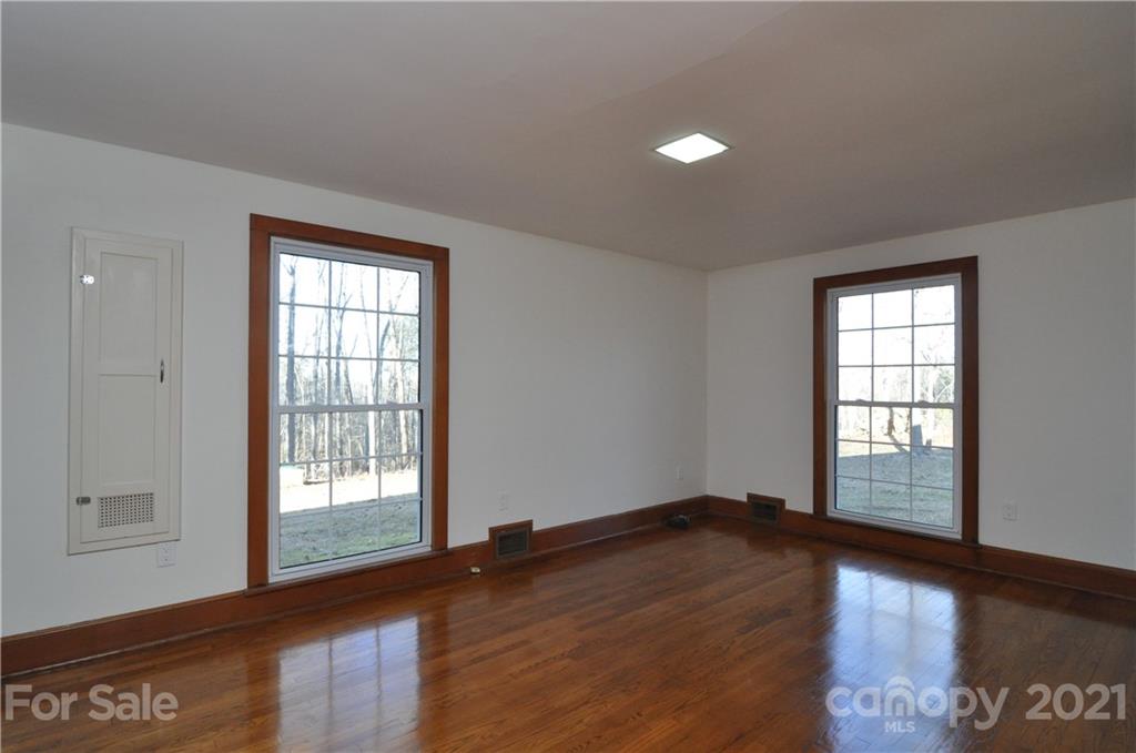 1011 Redland Road Landrum, SC 29356 - Photo 34 of 45 an empty room with wooden floor and windows