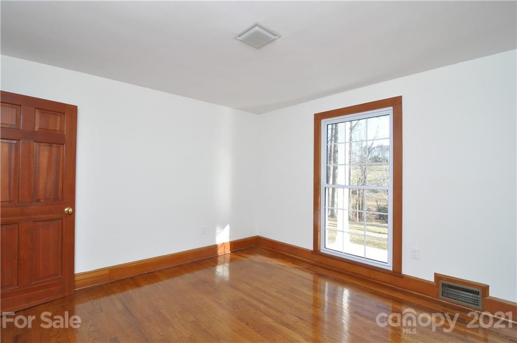 1011 Redland Road Landrum, SC 29356 - Photo 38 of 45 an empty room with wooden floor and windows