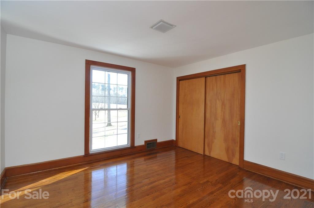 1011 Redland Road Landrum, SC 29356 - Photo 39 of 45 an empty room with wooden floor and windows