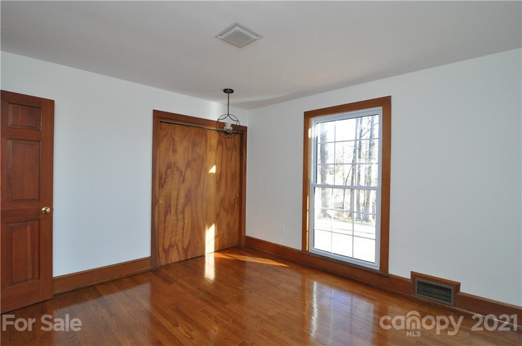 1011 Redland Road Landrum, SC 29356 - Photo 41 of 45 a view of an empty room with window and wooden floor