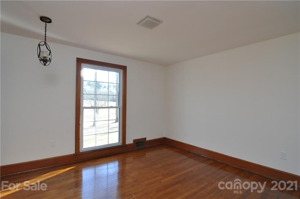1011 Redland Road Landrum, SC 29356 - Photo 42 of 45 a view of empty room with wooden floor and fan