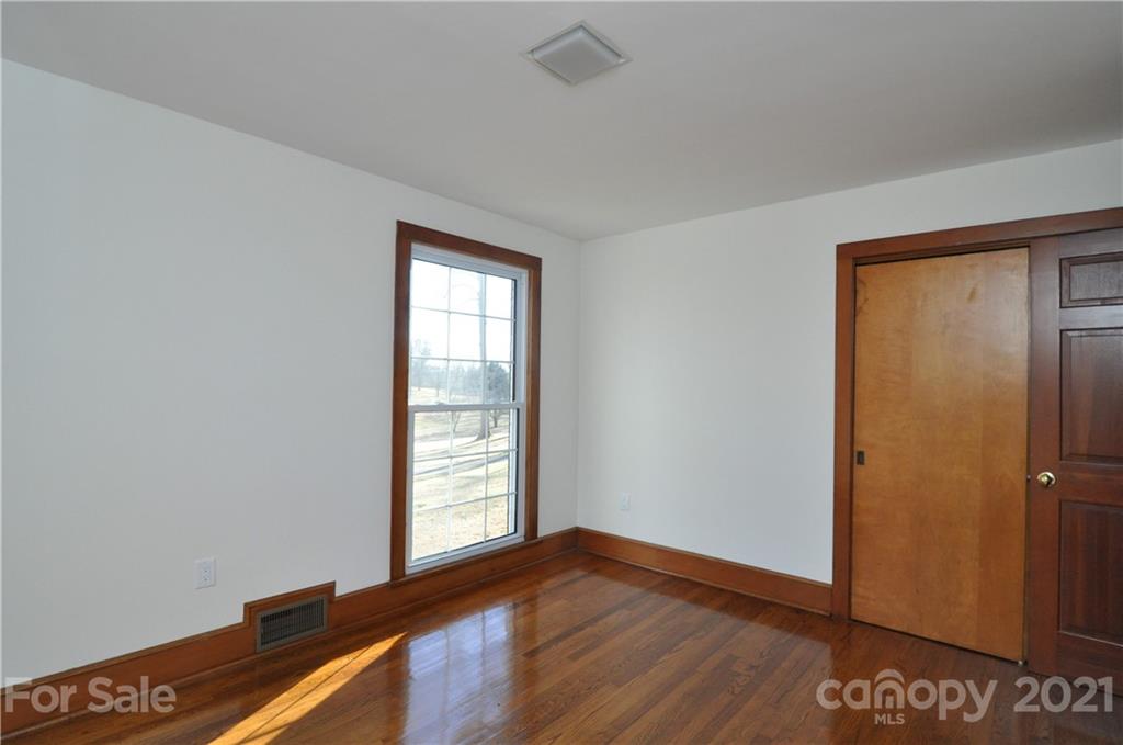 1011 Redland Road Landrum, SC 29356 - Photo 44 of 45 an empty room with wooden floor and windows