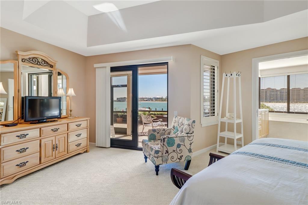 400 La Peninsula Boulevard, Unit 404 Naples, FL 34113 - Photo 11 of 19 a spacious bedroom with two beds and a large window