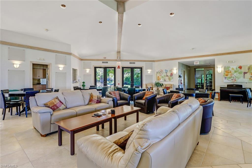 400 La Peninsula Boulevard, Unit 404 Naples, FL 34113 - Photo 17 of 19 a living room with lots of furniture and a large window