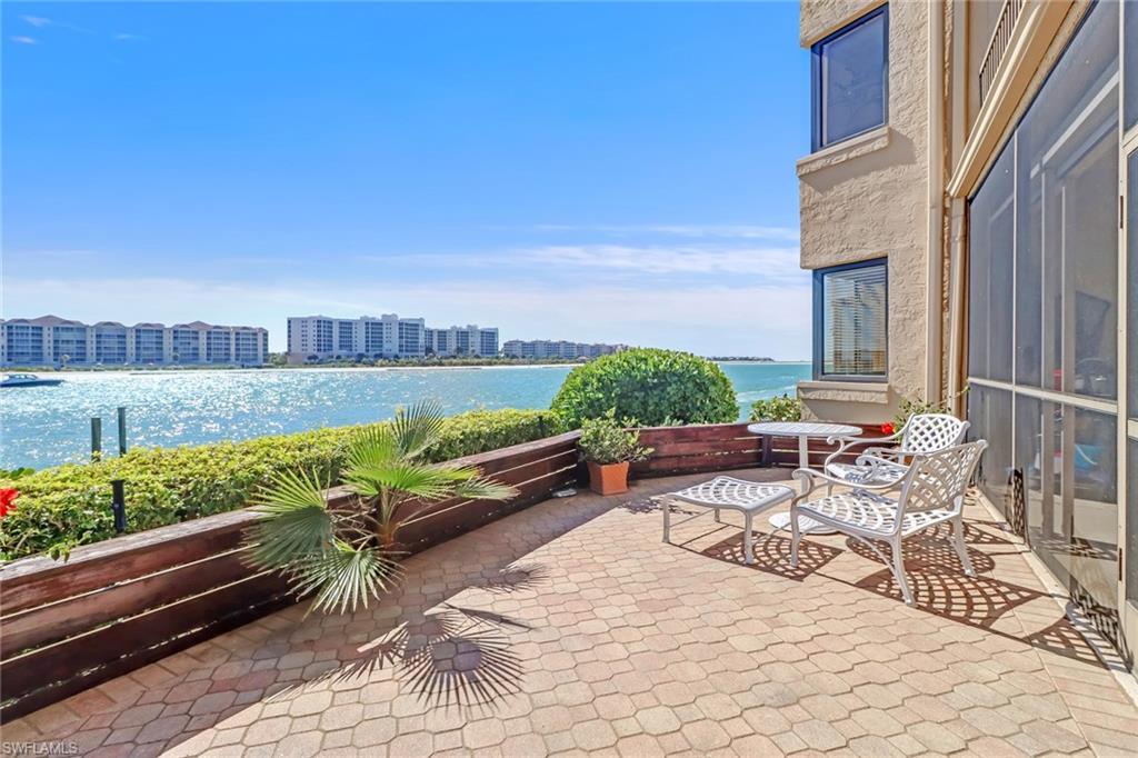 400 La Peninsula Boulevard, Unit 404 Naples, FL 34113 - Photo 4 of 19 a view of a patio with couches and potted plants