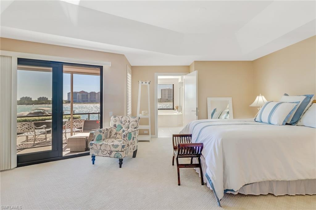400 La Peninsula Boulevard, Unit 404 Naples, FL 34113 - Photo 10 of 19 a spacious bedroom with a bed and large windows