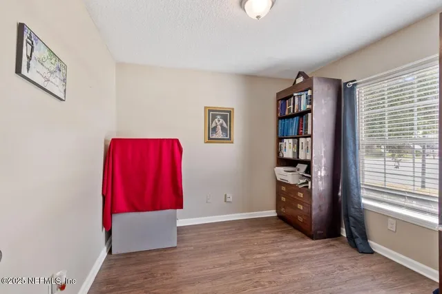 a view of a room with furniture and wooden floor