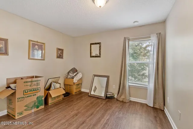 a view of a room with lounge chair and windows