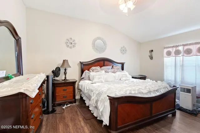 a bedroom with a bed and a chandelier
