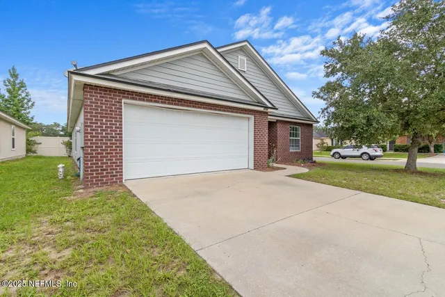 a front view of a house with a yard and garage