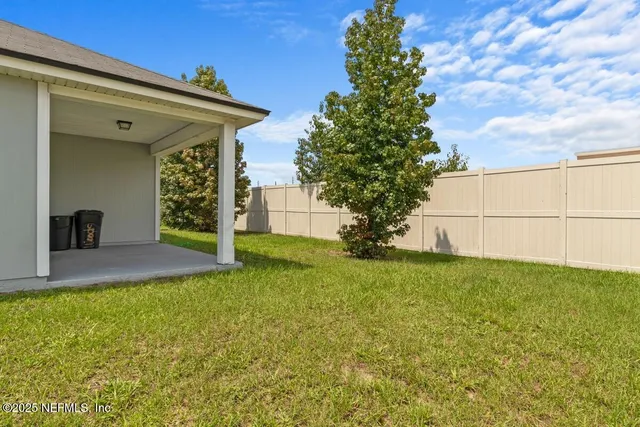 a view of a house with a backyard