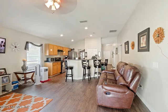 a living room with furniture and kitchen view