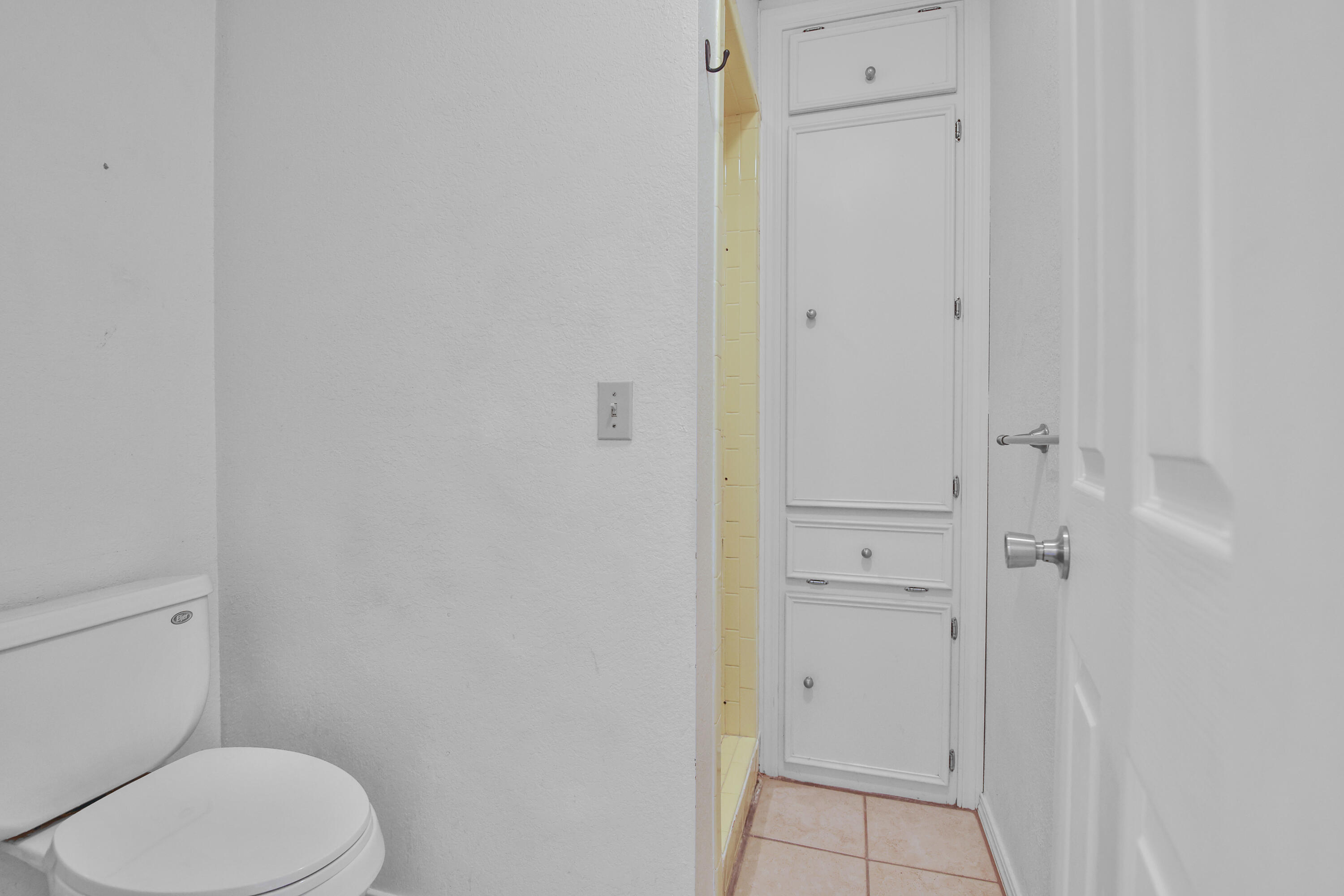 18 Highland Drive Ransom Canyon, TX 79366 - Photo 17 of 28 a white toilet sitting next to a bathroom sink