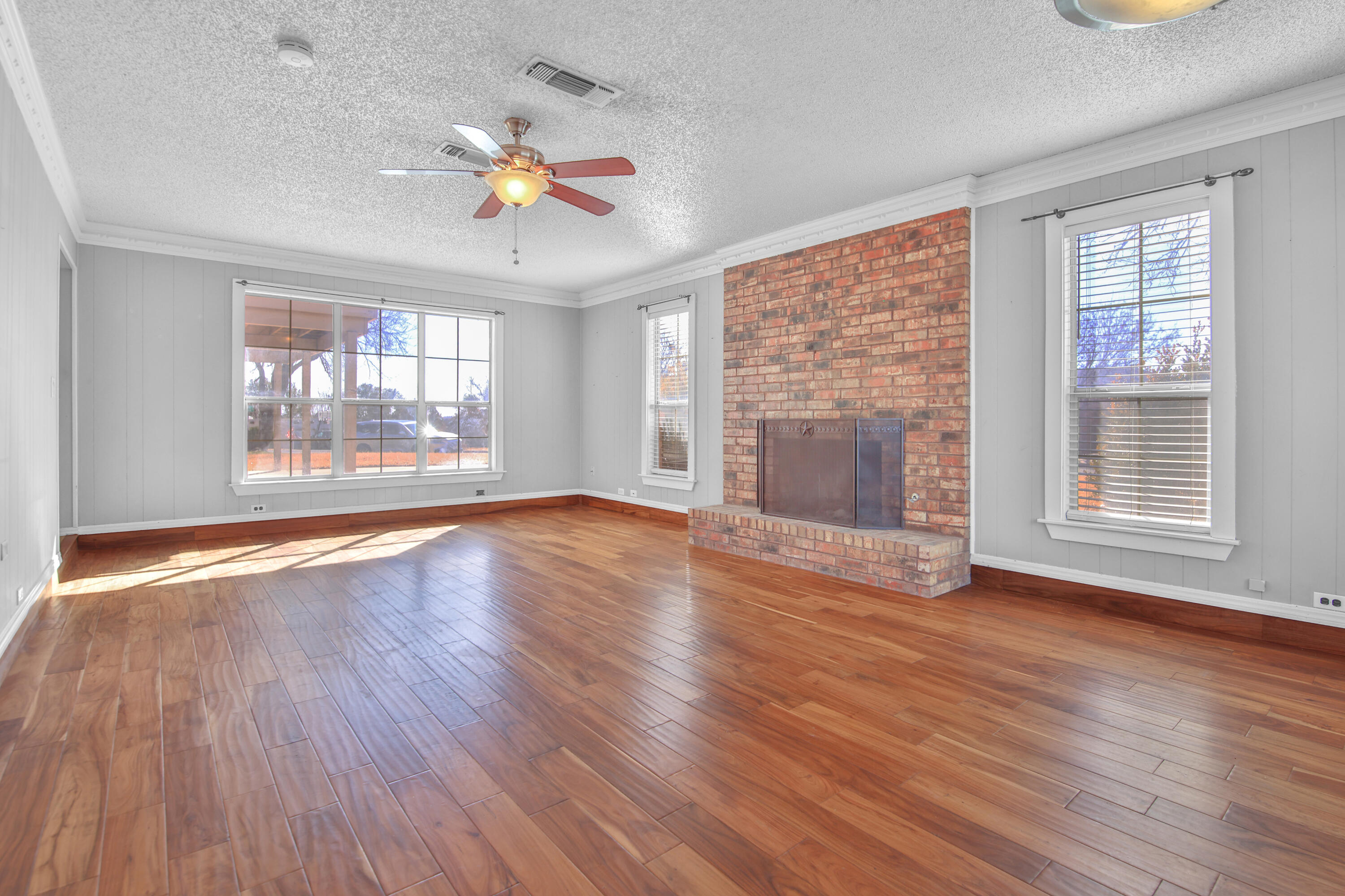 18 Highland Drive Ransom Canyon, TX 79366 - Photo 4 of 28 an empty room with wooden floor chandelier and windows