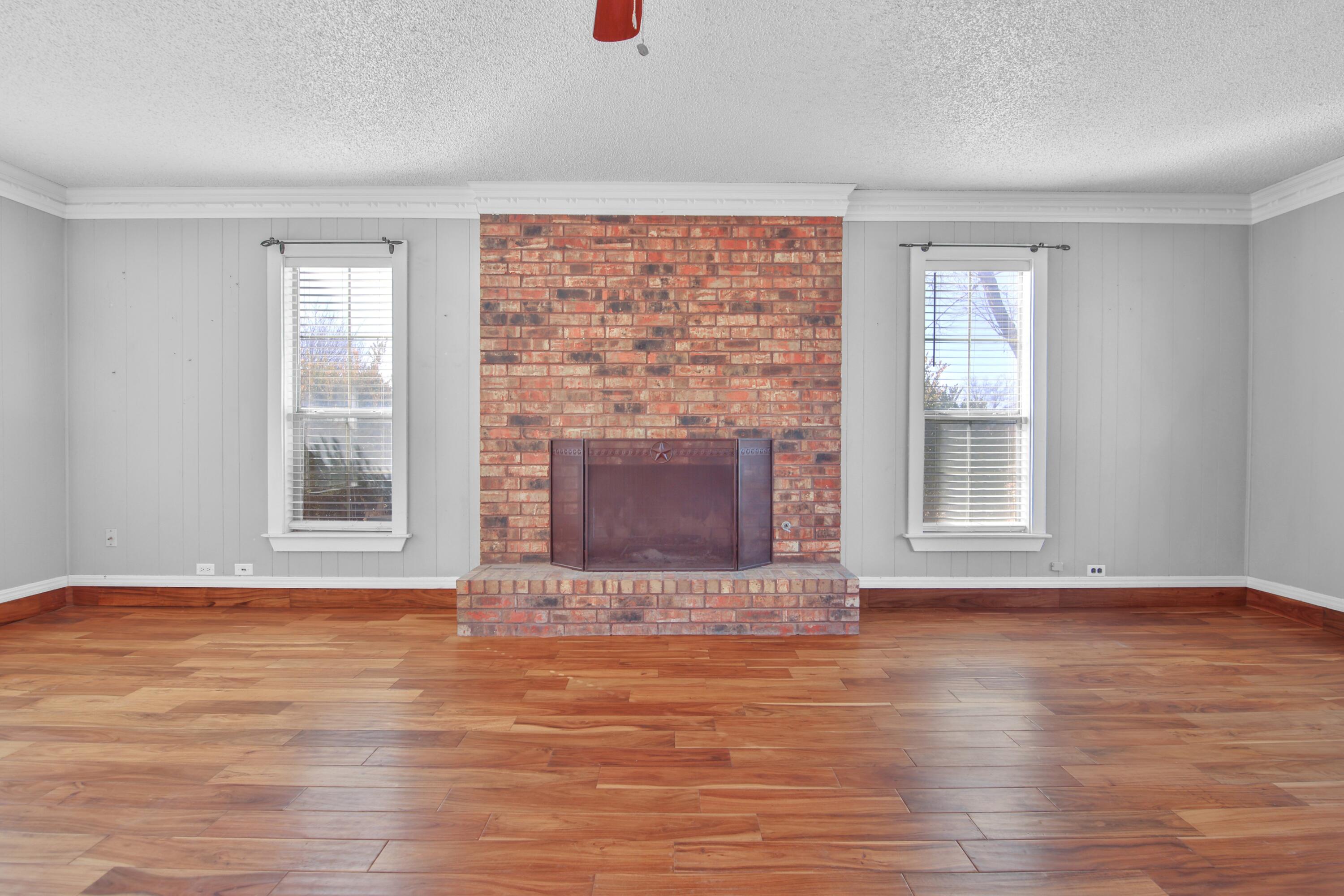 18 Highland Drive Ransom Canyon, TX 79366 - Photo 5 of 28 a view of an empty room with wooden floor and a window