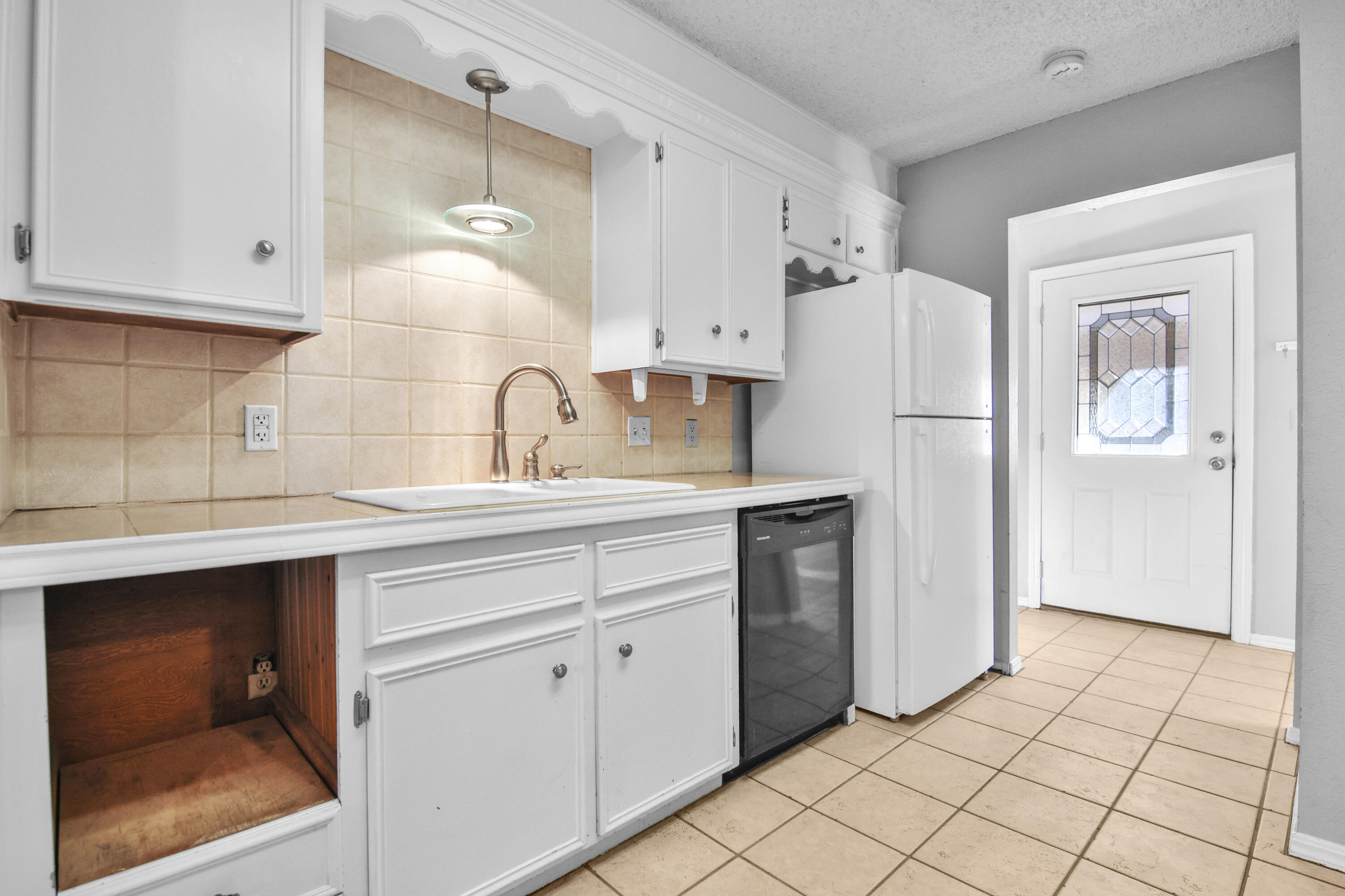 18 Highland Drive Ransom Canyon, TX 79366 - Photo 9 of 28 a kitchen with a sink cabinets and refrigerator