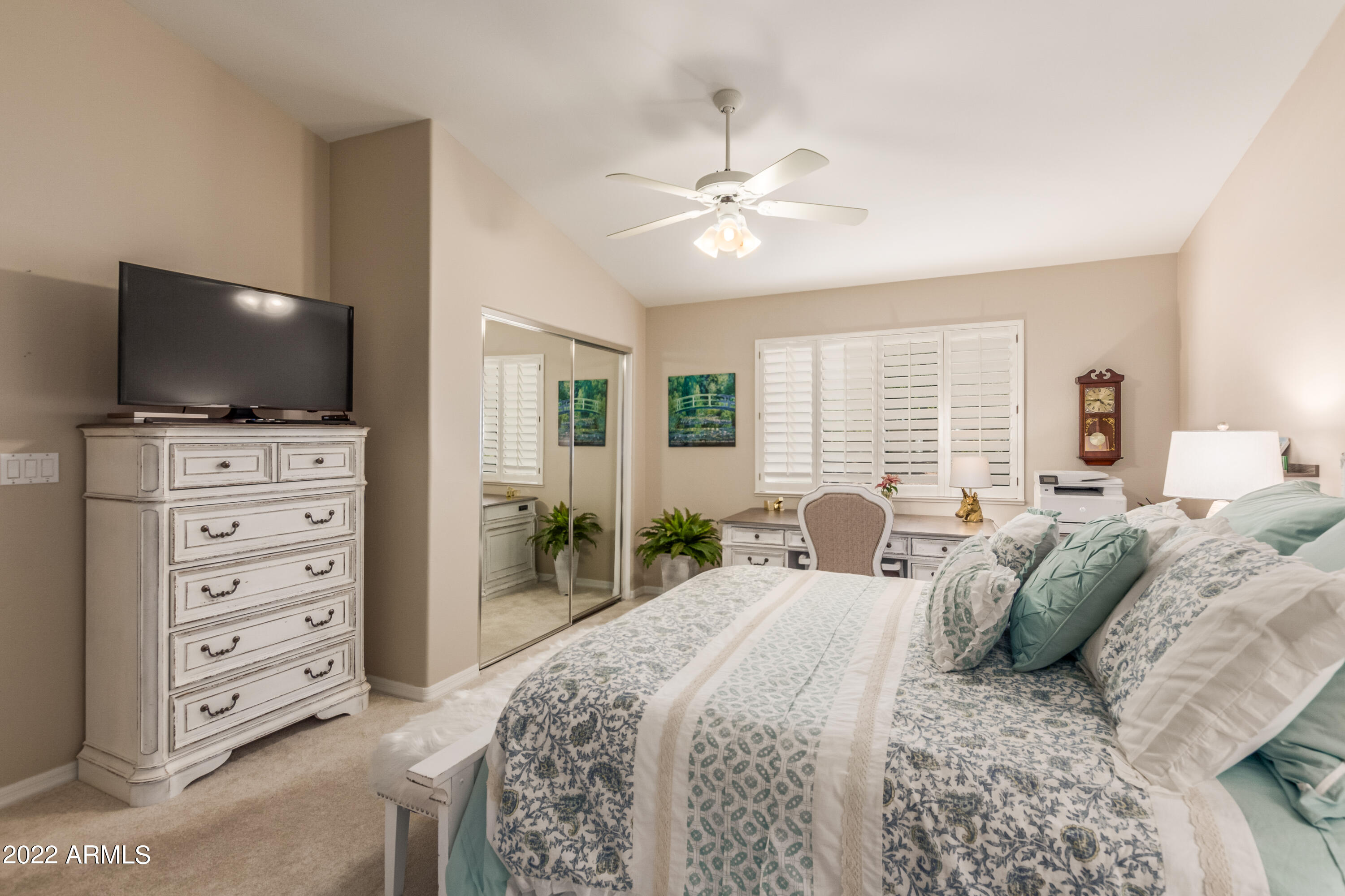 5830 East McKellips Road, Unit 76 Mesa, AZ 85215 - Photo 19 of 33 a bedroom with a bed and a flat screen tv