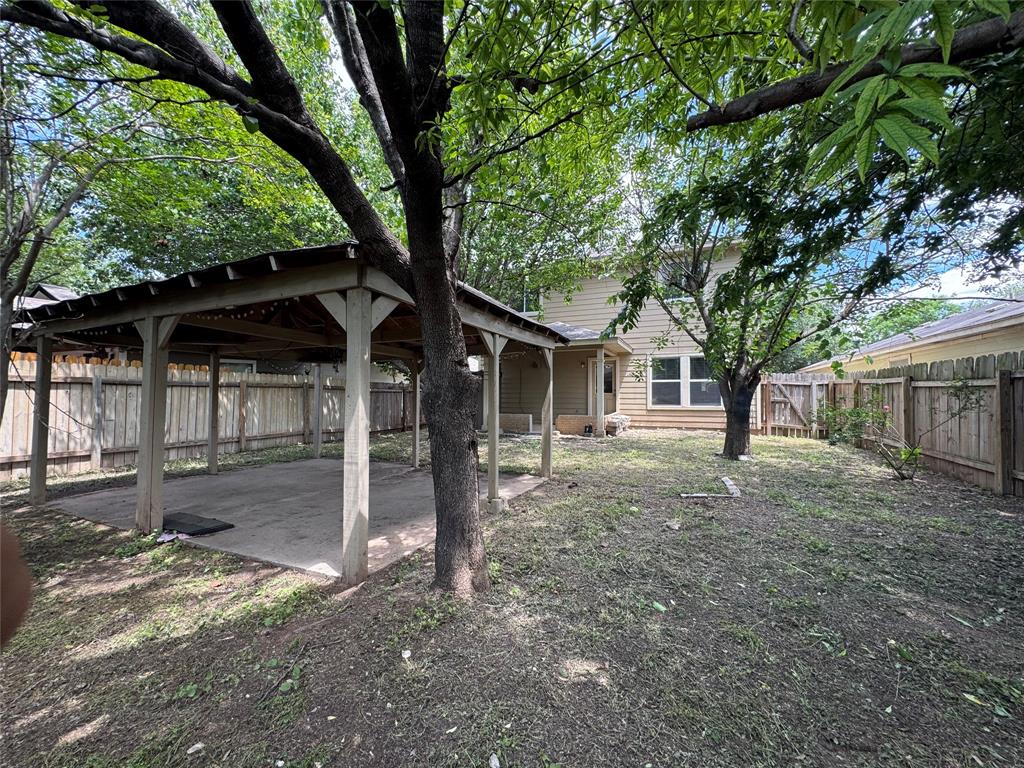 3200 Crownover Street Austin, TX 78725 - Photo 3 of 23 A spacious backyard with mature trees and a covered patio for outdoor enjoyment.