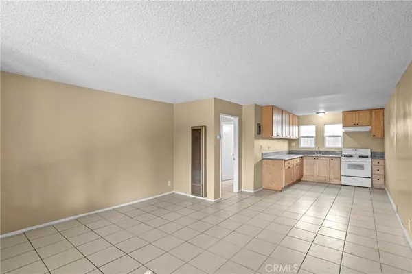 a large white kitchen with a sink and cabinets