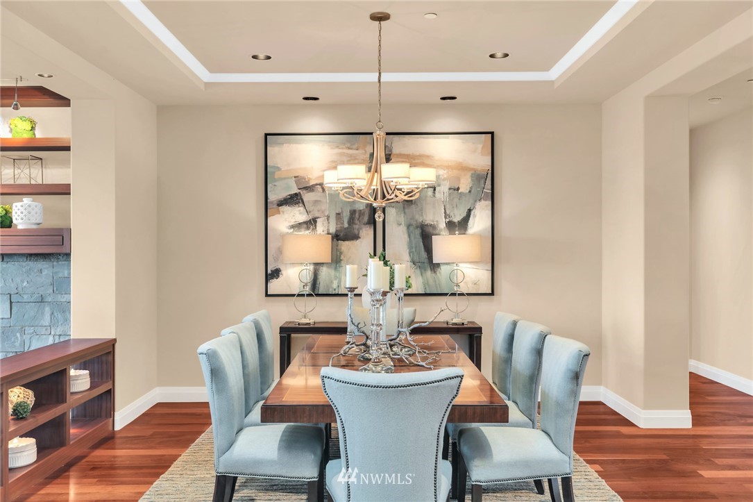 8477 Ridge Road Medina, WA 98039 - Photo 7 of 24 a dining room with furniture a chandelier and wooden floor