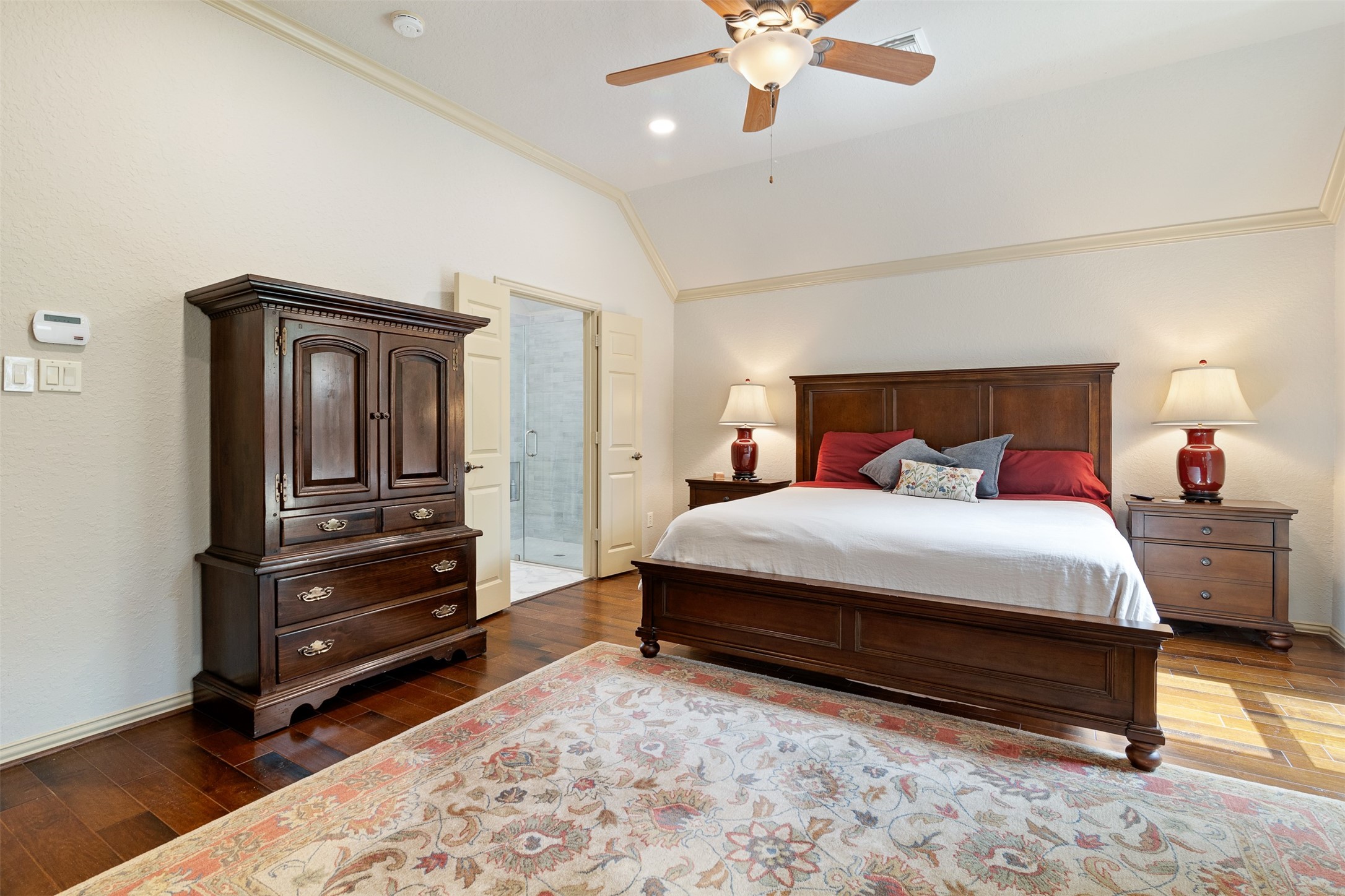19507 Remington Manor Street Spring, TX 77379 - Photo 15 of 33 The primary bedroom has crown molding and double doors leading to the en-suite bathroom.