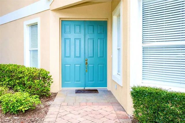 a view of a dining room with furniture and a chandelier