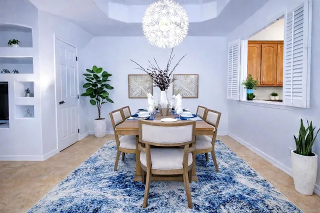 a view of a dining room with furniture and chandelier