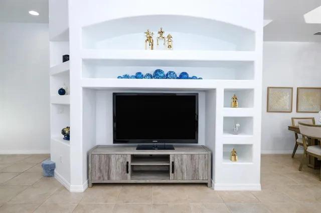 a kitchen with stainless steel appliances granite countertop a stove top oven a refrigerator a sink and dishwasher