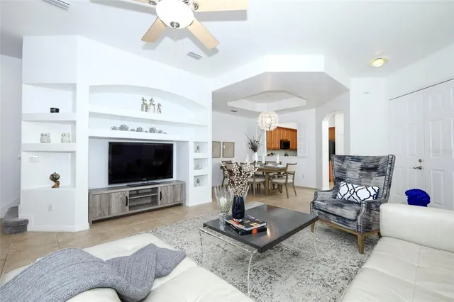 a kitchen with stainless steel appliances granite countertop a stove top oven a refrigerator a sink and dishwasher with white cabinets