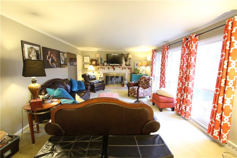 111 Taylor Run Road Monongahela, PA 15063 - Photo 2 of 25 Large 22x13 Living Room w/ 3 Massive Floor to Ceiling Windows (replaced 6-19, also directly below in lower level) calling in the Natural Light & Showing off Nature's Beauty! (YMCA borders this property so no neighbors will ever build behind and the View is Gorgeous!!!). Brass Hearth Brick Log Burning Fireplace brings warmth to this Family area