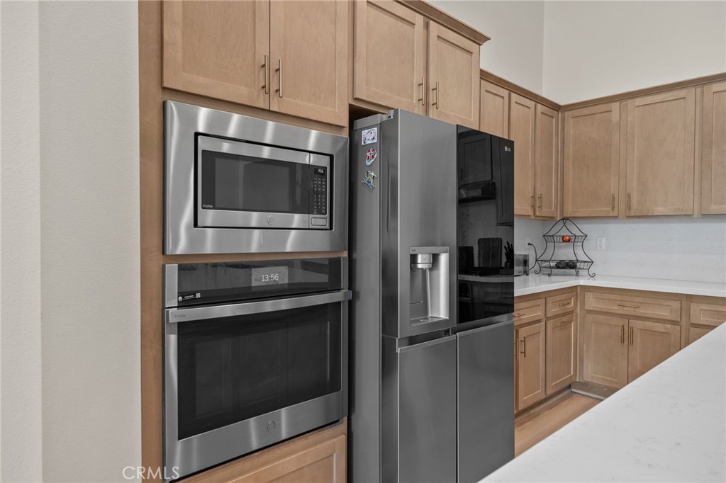 34972 South Serrano Square Yucaipa, CA 92399 - Photo 14 of 48 a kitchen with stainless steel appliances and cabinets