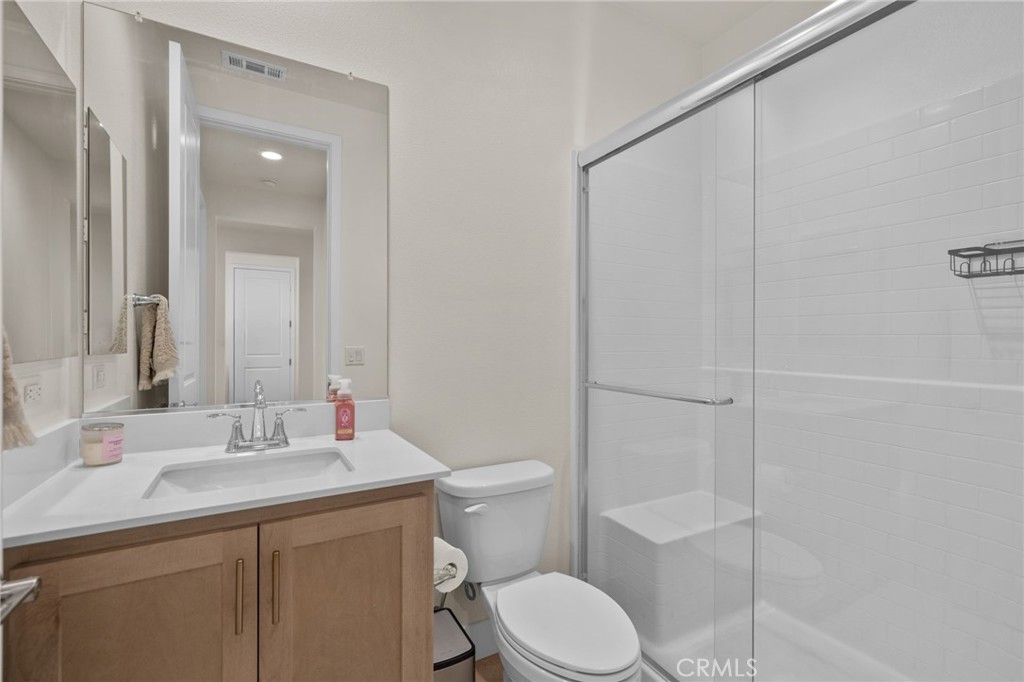 34972 South Serrano Square Yucaipa, CA 92399 - Photo 19 of 48 a bathroom with a sink a toilet and shower