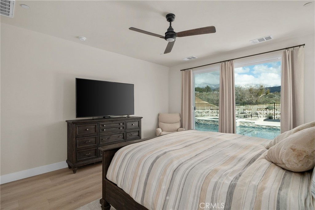 34972 South Serrano Square Yucaipa, CA 92399 - Photo 23 of 48 a bedroom with a bed and a flat screen tv