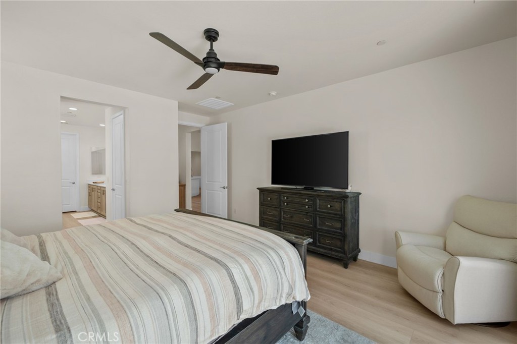 34972 South Serrano Square Yucaipa, CA 92399 - Photo 24 of 48 a bedroom with a bed and a flat screen tv