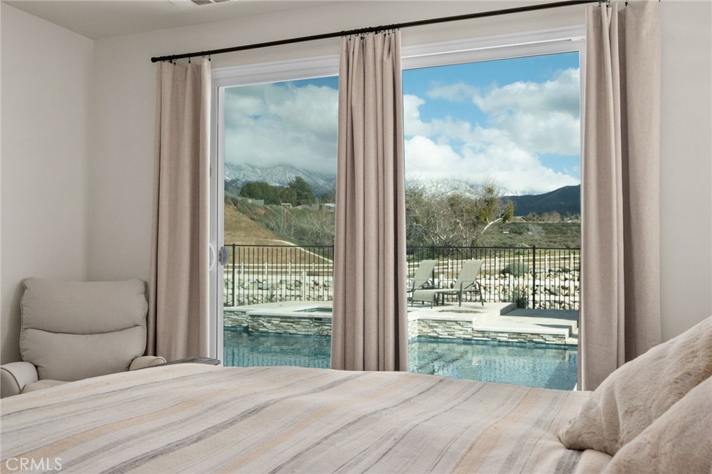34972 South Serrano Square Yucaipa, CA 92399 - Photo 25 of 48 a bedroom with a large window and a bed