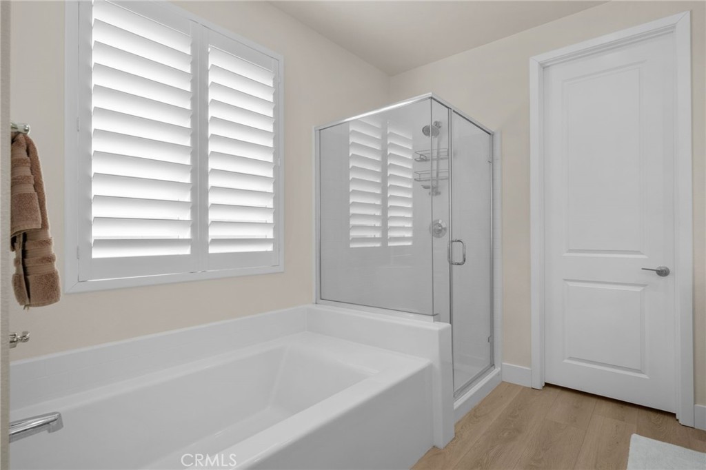 34972 South Serrano Square Yucaipa, CA 92399 - Photo 27 of 48 a bathroom with a bathtub and a shower
