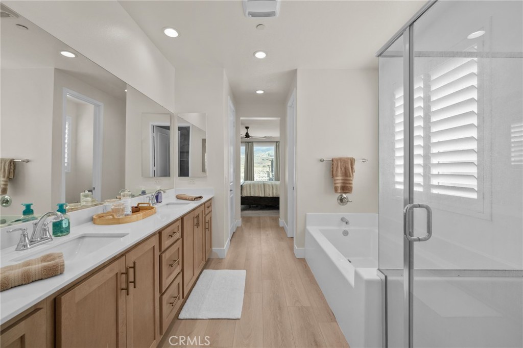 34972 South Serrano Square Yucaipa, CA 92399 - Photo 28 of 48 a bathroom with a sink a tub and a mirror