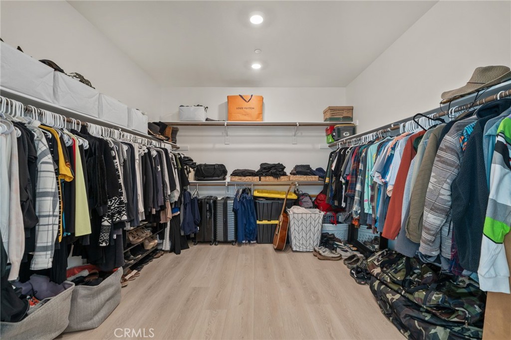 34972 South Serrano Square Yucaipa, CA 92399 - Photo 29 of 48 a view of walk in closet with clothes