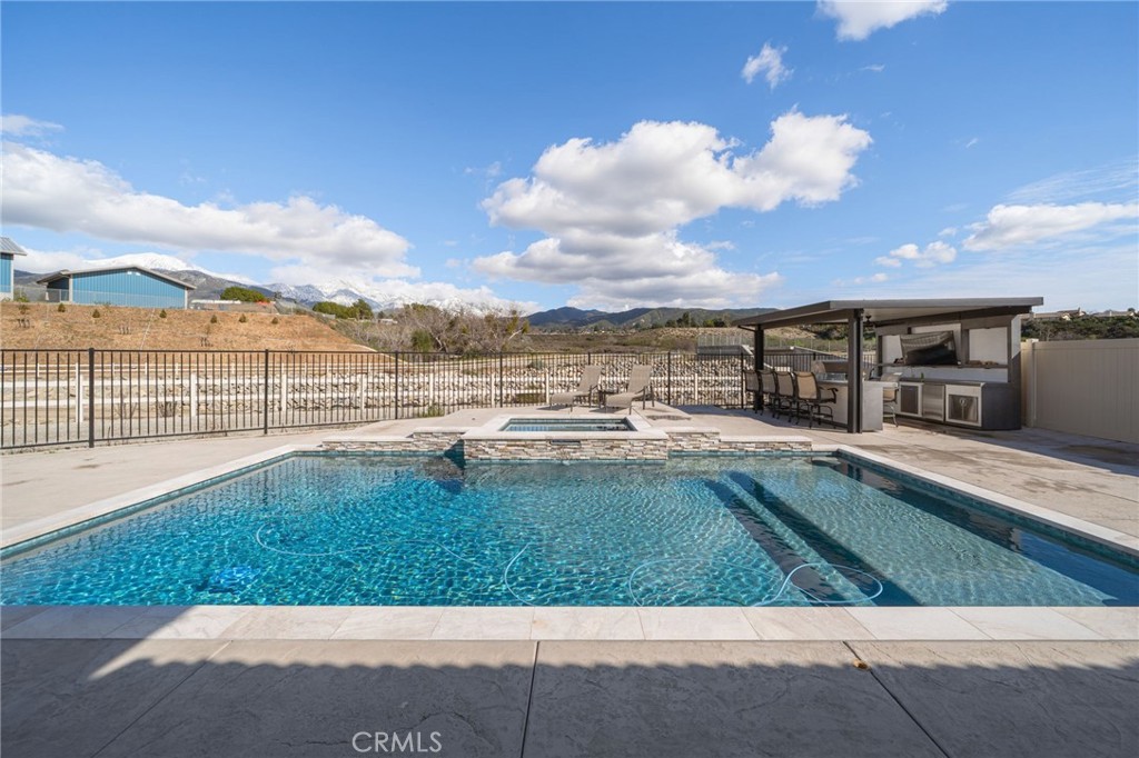 34972 South Serrano Square Yucaipa, CA 92399 - Photo 3 of 48 a view of swimming pool with lawn chairs and large trees