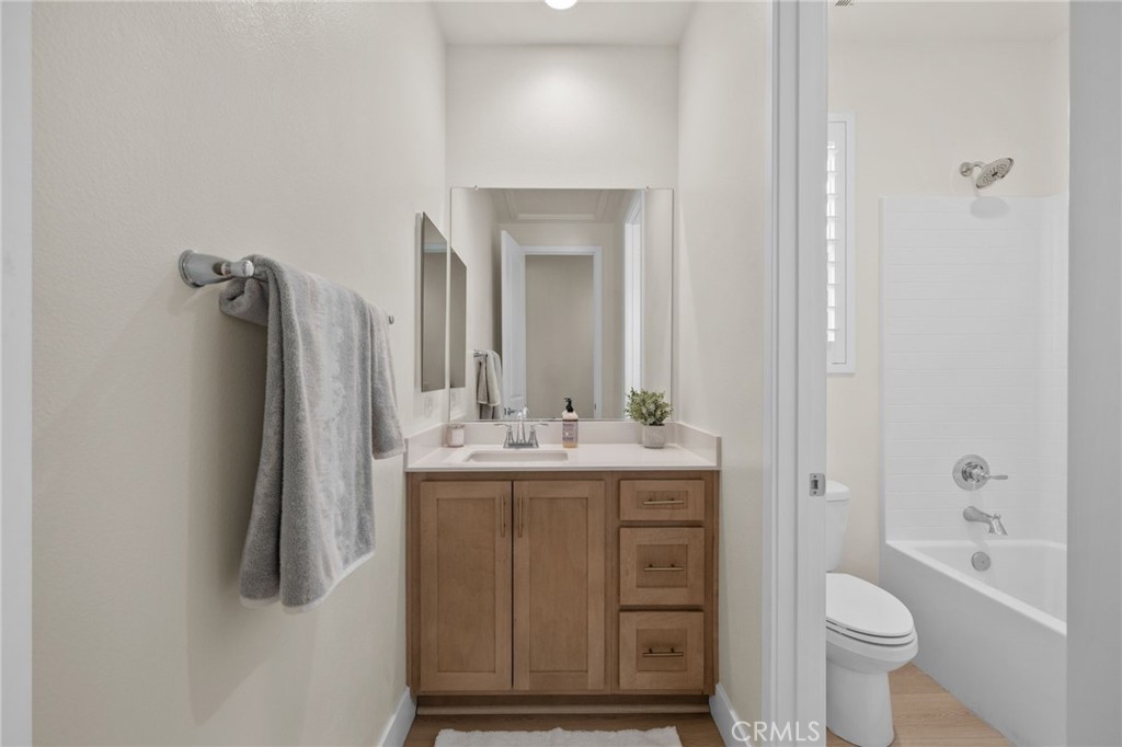 34972 South Serrano Square Yucaipa, CA 92399 - Photo 33 of 48 a bathroom with a granite countertop sink a toilet and a mirror
