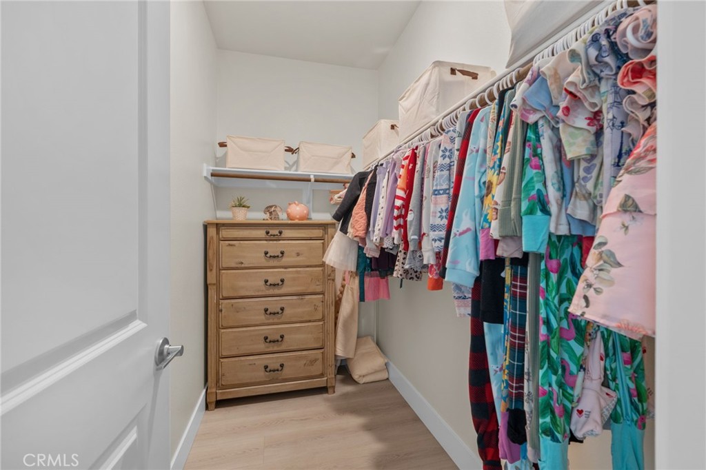 34972 South Serrano Square Yucaipa, CA 92399 - Photo 34 of 48 a view of walk in closet with clothes and shoes