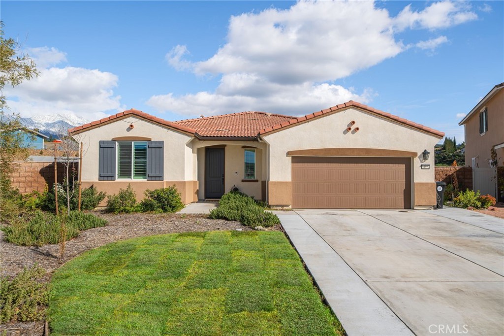 34972 South Serrano Square Yucaipa, CA 92399 - Photo 5 of 48 a front view of a house with a garden and yard