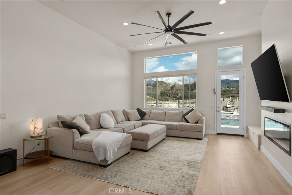 34972 South Serrano Square Yucaipa, CA 92399 - Photo 7 of 48 a living room with furniture a flat screen tv and a large window