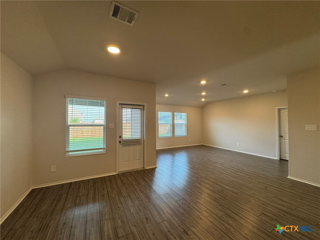 208 Ida Loop Seguin, TX 78155 - Photo 5 of 16 an empty room with wooden floor and windows