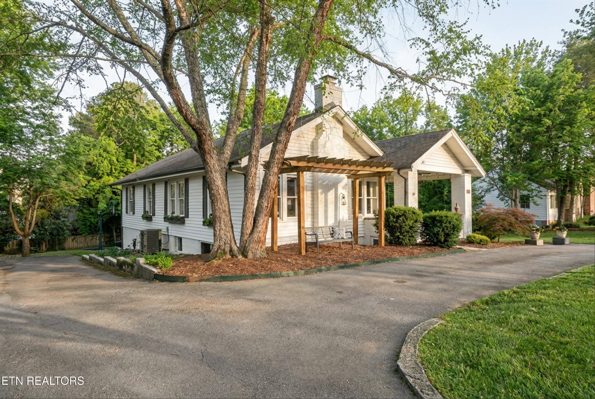 6911 Nubbin Ridge Drive Knoxville, TN 37919 - Photo 1 of 46 a front view of a house with a garden