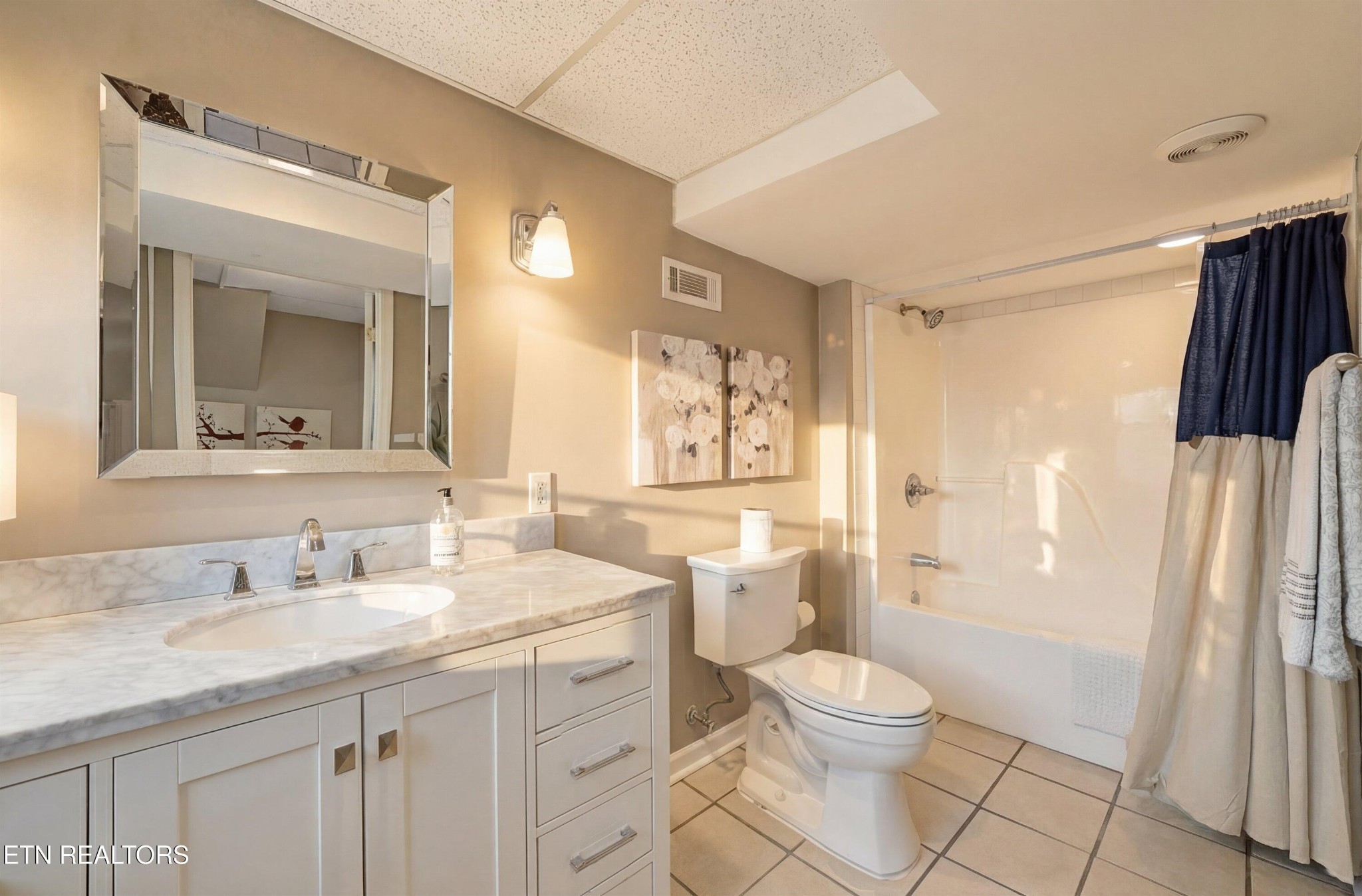 6911 Nubbin Ridge Drive Knoxville, TN 37919 - Photo 30 of 46 a bathroom with a granite countertop sink toilet a large mirror a bathtub and shower