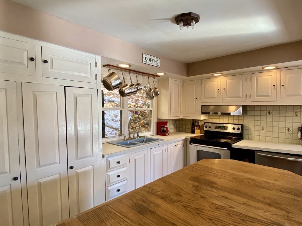 194 Buckland Road Ashfield, MA 01330 - Photo 8 of 19 a kitchen with granite countertop a refrigerator stove sink and cabinets