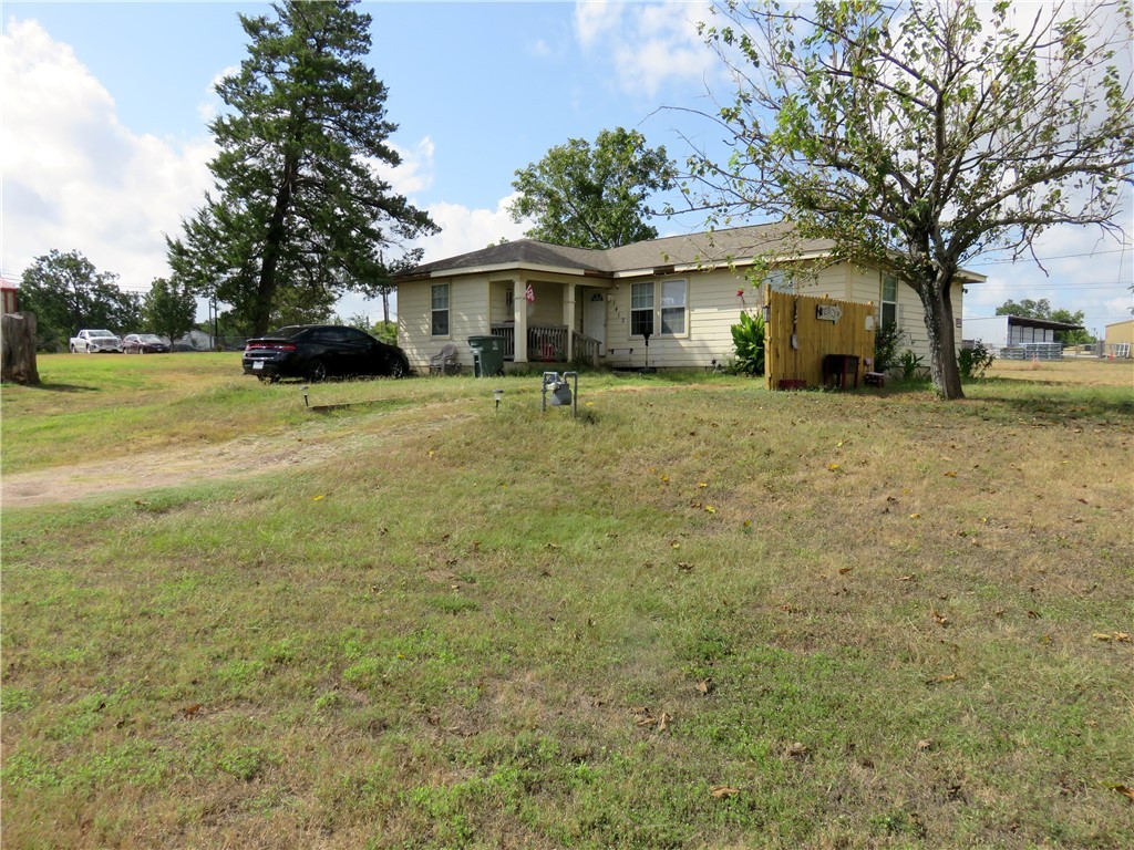 1413 Sandy Point Road Bryan, TX 77803 - Photo 2 of 22 a front view of a house with a garden
